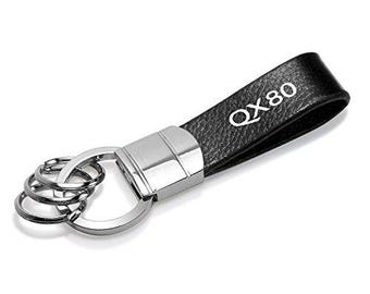 Imagen de iPick para Infiniti QX80 con correa de cuero auténtico negra y gancho redondo cromado, llavero de metal, licencia oficial.