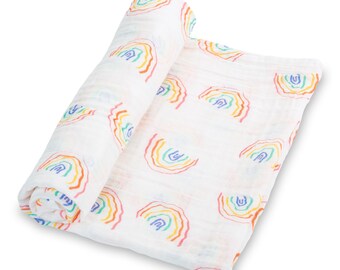 May include: White muslin swaddle blanket featuring a repeating rainbow pattern in red, orange, yellow, green, and blue. The blanket is rolled up, showcasing the soft, lightweight fabric. Ideal for swaddling or as a stroller cover.