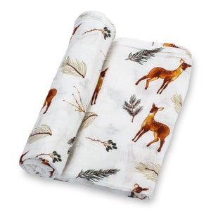Soft baby swaddle featuring a charming deer theme with delicate fawn prints, ideal for gender-neutral nurseries and cozy snuggles.