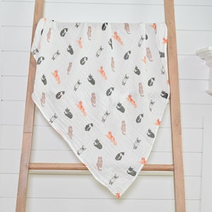 The swaddle's large 47"x47" size is perfect for wrapping or draping, featuring an adorable cat pattern.