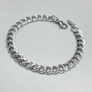 May include: A silver chain bracelet with a lobster clasp.