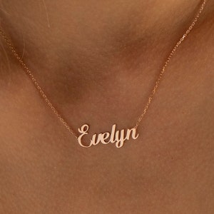 May include: A rose gold necklace with the name "Evelyn" written in a cursive font.