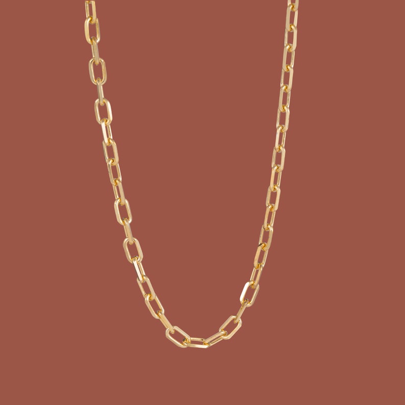 May include: A gold chain necklace with a classic link design.