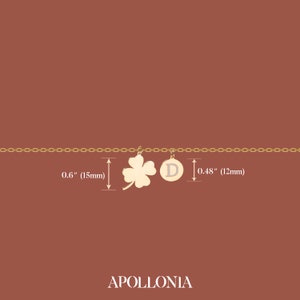 May include: Gold chain necklace with a four-leaf clover charm and a round charm with the letter "D" on it. The clover charm is 0.6 inches (15 mm) wide and the round charm is 0.48 inches (12 mm) wide.