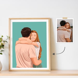 May include: A framed portrait of a couple embracing, rendered in a cartoon style. The artwork features a man and a woman in a warm embrace, set against a teal background. A smaller photograph is displayed next to the framed art.