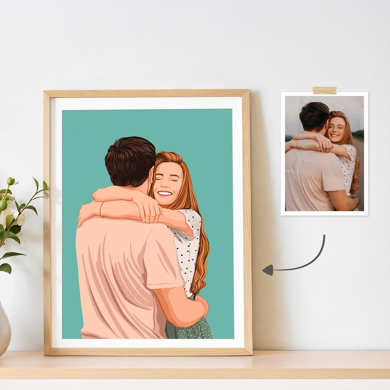 May include: A framed portrait of a couple embracing, rendered in a cartoon style. The artwork features a man and a woman in a warm embrace, set against a teal background. A smaller photograph is displayed next to the framed art.
