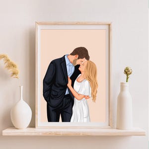 May include: A framed illustration of a couple embracing. The man wears a black suit and the woman is in a white dress. The background is a soft peach color. The artwork is displayed on a white shelf with decorative vases.
