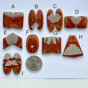 May include: Assortment of 9 pairs of polished, cut, and paired agate cabochons in various shapes and sizes. The cabochons are a mix of red, orange, and white colors. The cabochons are labeled with letters A through I.