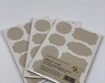 May include: A pack of 80 brown kraft paper labels with a variety of shapes, including circles, ovals, and rectangles. The labels are packaged in a clear plastic bag and have the text "Artikel-Nr.: G1300 ENDI-HAFT Graspapier-Etiketten, Sortiment 80 6 Etiketten, 10 1 Blatt je Pack" printed on the back.