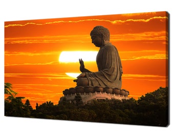 May include: A large, dark bronze statue of Buddha sitting in meditation against a vibrant orange sunset. The statue is perched on a hilltop with lush green trees in the foreground.
