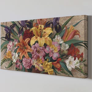May include: A floral canvas print depicting a colourful bouquet of lilies, irises, and other flowers in shades of yellow, orange, pink, and purple. The artwork has a textured background and is displayed on a white wall.