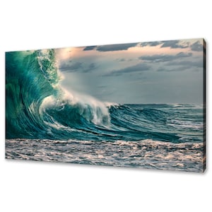 May include: A large, powerful wave crashes in the ocean. The wave is a vibrant teal green color with white foam at the crest. The sky is a cloudy, light blue with a hint of pink in the distance.