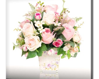 May include: A bouquet of pink roses and white flowers arranged in a floral patterned ceramic pot. The flowers are on a white background.