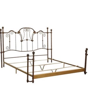 Puede incluir: Una estructura de cama de metal en color bronce oscuro con un cabecero alto que presenta volutas intrincadas y barras verticales. El marco incluye cuatro postes esquineros rematados con remates esféricos y una base rectangular.