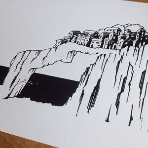 May include: Black and white illustration of a village perched on a cliff overlooking the sea. The village is made up of several buildings with windows and doors. The cliff is tall and rocky, with a large archway in the middle. The sea is dark and choppy.