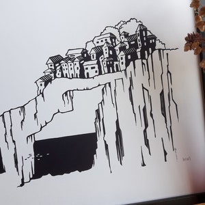 May include: Black and white illustration of a village perched on a cliff overlooking the sea. The village is made up of several small houses with windows and doors. The cliff is tall and rocky, with a large archway at the bottom. The sea is dark and choppy, with a few small birds flying over the water.