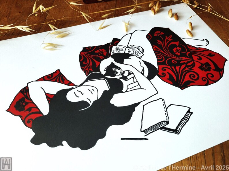 May include: Black and white illustration of a person reclining with a cat, reading a book. The person is wearing a black top and is resting on a red pillow with a black floral design. Two books and a pencil are also visible.
