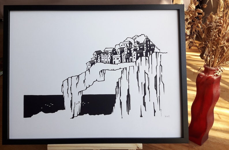 May include: Black and white illustration of a village perched on a cliff overlooking the sea. The village is made up of several small houses with pointed roofs. The cliff is tall and jagged, with a large opening in the middle. The sea is dark and choppy.