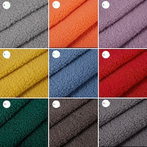 May include: A collection of 10 fabric swatches in various colours, including grey, orange, purple, yellow, blue, red, green, brown, and dark grey. The fabric has a soft, fuzzy texture.