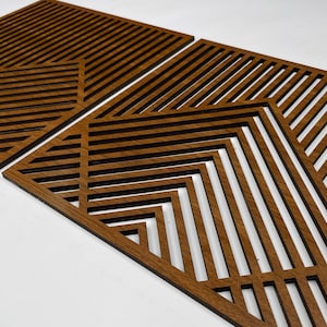 May include: Two brown wooden wall decor panels with geometric patterns of intersecting lines. The panels are made of thin wood and have a natural wood finish.