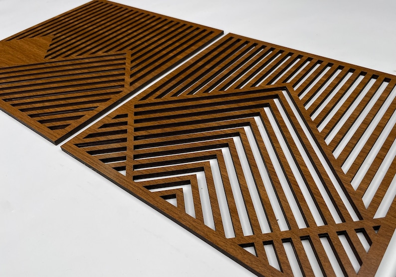 May include: Two brown wooden wall decor panels with geometric patterns of intersecting lines. The panels are made of thin wood and have a natural wood finish.