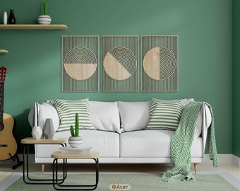 May include: A living room scene with a white sofa, two small wooden tables with black metal legs, and three framed wall art pieces. The wall is painted a muted green, and the room is decorated with green and white accents.