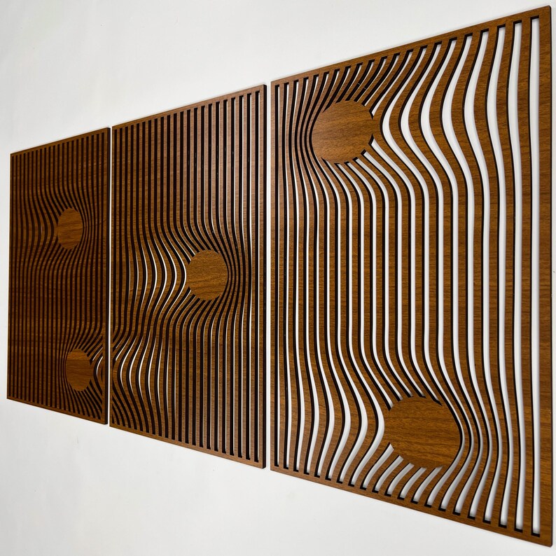 May include: Three wooden wall panels with a unique design. Each panel features a series of vertical lines that curve and bend, creating a wave-like effect. Circular wooden accents are incorporated into the design, adding visual interest. The panels are a warm brown color.