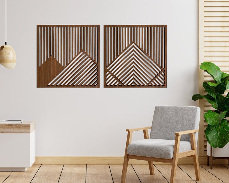 May include: Two wooden wall decor pieces featuring a geometric pattern of lines and triangles. The pieces are brown and have a natural wood finish. They are hanging on a white wall.