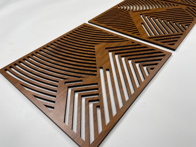 May include: Two brown wooden wall panels with a geometric pattern of lines and curves.