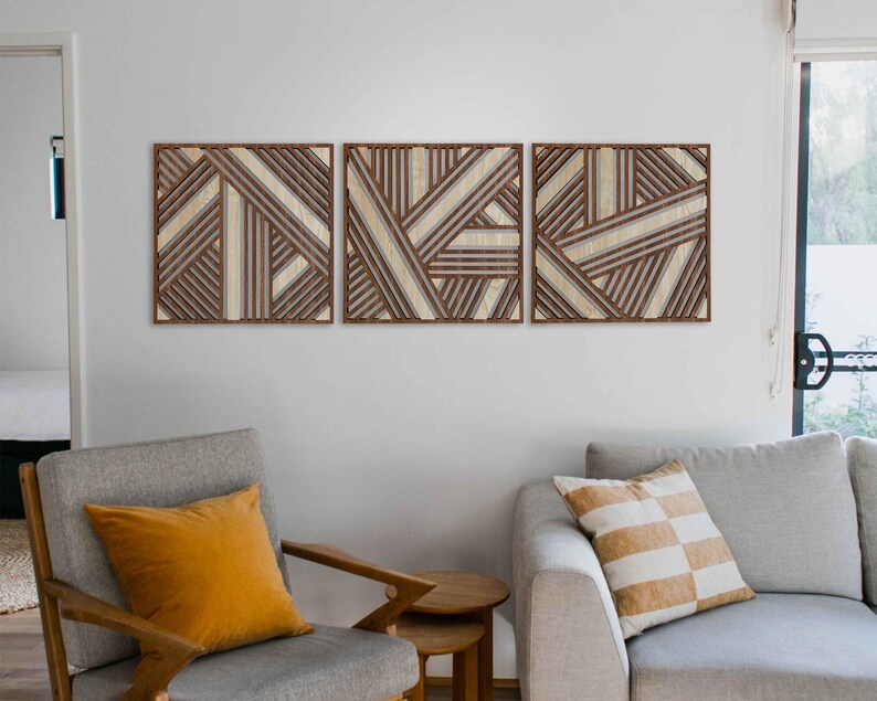 May include: Three wooden wall art panels with a geometric pattern of brown and white stripes. The panels are arranged horizontally and are hung on a white wall.