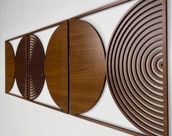 May include: A wall decor piece made of wood with a geometric design of three overlapping circles. The circles are cut out in a concentric pattern, creating a modern and abstract look. The piece is painted in a light brown color.