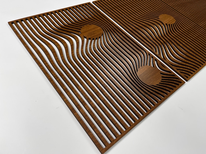 May include: Wooden wall art panels with a unique design. The panels are made of brown wood and feature a series of curved, parallel lines. The design includes circular accents, creating a modern, abstract aesthetic. The panels are displayed against a white background.