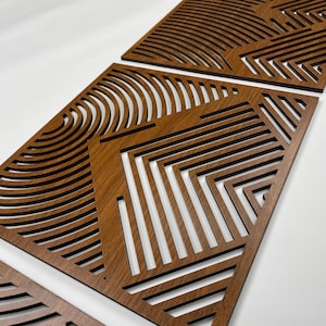 May include: Three wooden wall decor panels with a geometric pattern of lines and curves. The panels are made of a dark brown wood and have a natural wood grain finish.