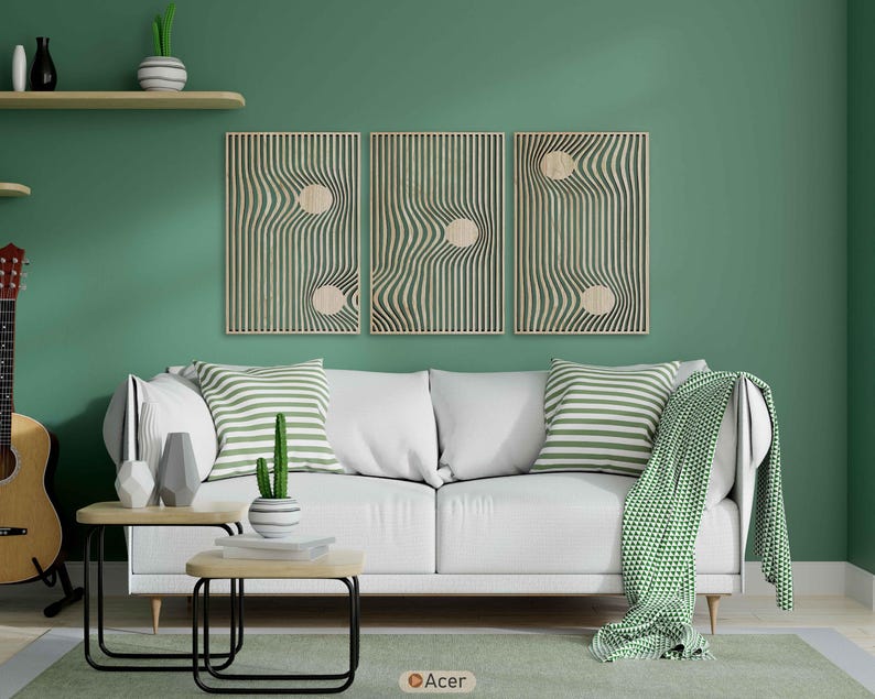 May include: A living room scene with a white sofa, green and white striped pillows, and a green throw blanket. Three wooden wall art pieces with a wavy design hang above the sofa. Two small wooden tables with black metal legs are in front of the sofa.