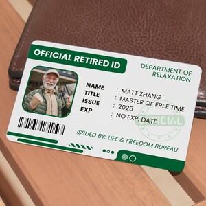 May include: A green and white official retired ID card with a photo of a man in a green jacket. The card reads "OFFICIAL RETIRED ID" and "DEPARTMENT OF RELAXATION". The card also includes the name "MATT ZHANG", the title "MASTER OF FREE TIME", the issue date "2025", and the expiration date "NO EXP. DATE". The card is issued by "LIFE & FREEDOM BUREAU".