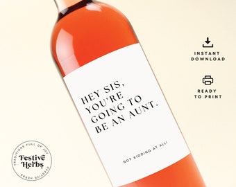 May include: Printable wine bottle label with the text "Hey Sis, You're Going To Be An Aunt."  The label is white with black text and is ready to be printed.  The label is on a pink wine bottle.