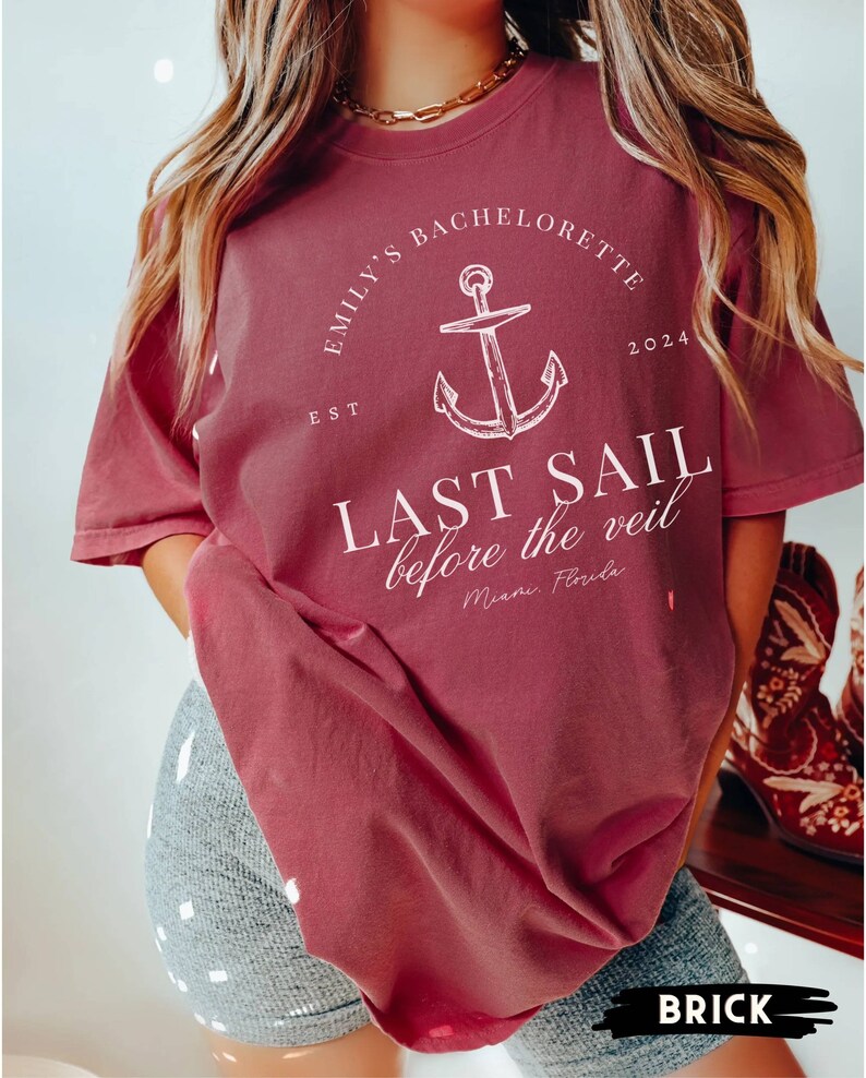 May include: A maroon t-shirt with a white anchor graphic and the text "Emily's Bachelorette Est 2024 Last Sail Before the Veil Miami Florida"