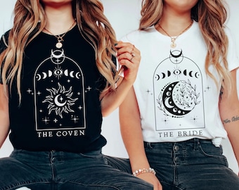 May include: Two women wearing black and white t-shirts with a moon and sun design. The black shirt says "The Coven" and the white shirt says "The Bride".