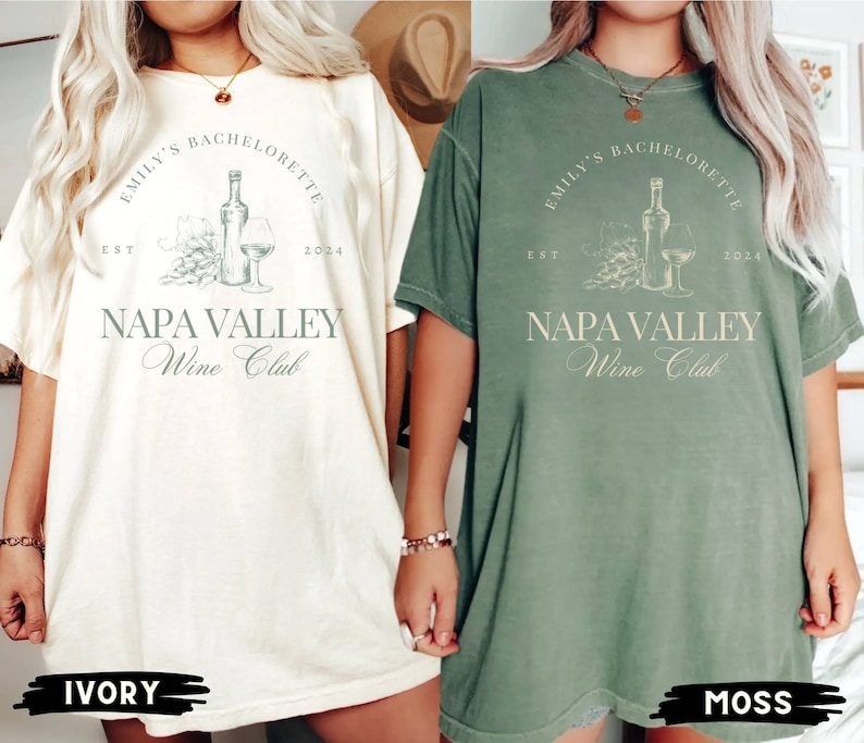 May include: Two oversized t-shirts with a vintage-inspired design. The shirts are in ivory and moss green colors. The design features a bottle of wine, a glass of wine, and grapes with the text "Emily's Bachelorette Est 2024 Napa Valley Wine Club".