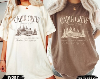 May include: Two t-shirts with a cabin crew design. The ivory t-shirt has the text "CABIN CREW Before I Do EMILY'S BACHELORETTE Jackson Hole, Wyoming". The espresso t-shirt has the text "CABIN CREW Before I Do EMILY'S BACHELORETTE Jackson Hole Wyoming".