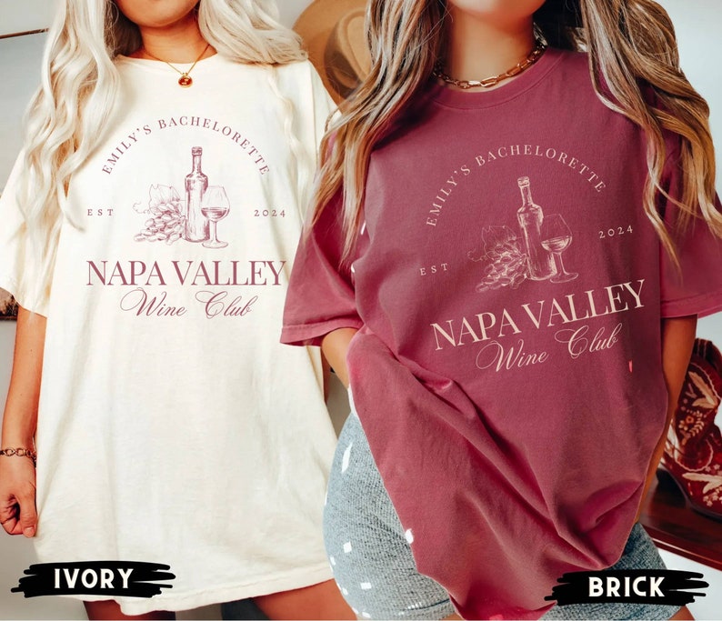May include: Two women wearing t-shirts with the text "Emily's Bachelorette Est 2024 Napa Valley Wine Club". The shirt on the left is ivory and the shirt on the right is brick.