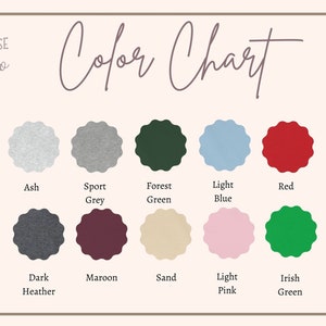 May include: Color chart showing 10 different colors of fabric. The colors are: Ash, Sport Grey, Forest Green, Light Blue, Red, Dark Heather, Maroon, Sand, Light Pink, and Irish Green.