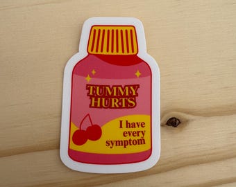May include: A sticker in the shape of a medicine bottle with the words "TUMMY HURTS" in red and yellow. Below the text are two cherries and the words "I have every symptom".