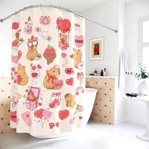 May include: A cream shower curtain with a repeating pattern of cartoon bears, hearts, and Valentine's Day illustrations. The design includes pink and red hearts, flowers, and the text "XOXO".
