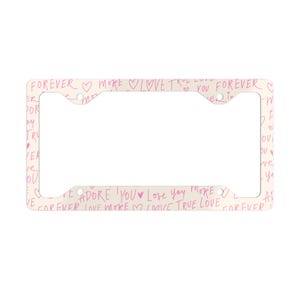 May include: A cream-coloured license plate frame featuring pink handwritten text with phrases such as "Forever" and "Love You," and heart symbols. The frame is rectangular with cutouts for mounting, and is designed to hold a standard UK license plate.