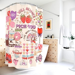 May include: A cream-colored shower curtain with a colorful, whimsical design. The curtain features illustrations of strawberries, donuts, coffee, hearts, and the words "I will always pick you" and "The world needs love".