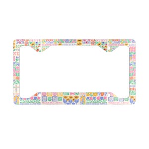 May include: License plate frame with a colorful floral pattern in pink, yellow, blue, and green. The frame has text that reads "LOVE", "GOD KEEPS", "ALWAYS PRAY", and "Flourish like a flower".