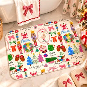 May include: A rectangular bath mat featuring a festive Christmas pattern on a white background. The design includes illustrations of nutcrackers, Santa Claus, dachshunds, Christmas trees, wreaths, bows, and text like Cheers and Santa Hot Cocoa Club.