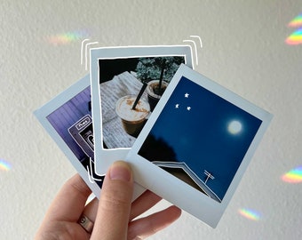 May include: Three instant photos with white borders. The first photo shows a plant in a pot with two iced coffees. The second photo shows a night sky with stars and a moon. The third photo shows a building with a power line.
