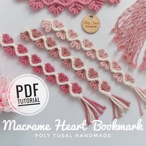 May include: Three pink and white macrame heart bookmarks with tassels. The bookmarks are made with a gradient of pink yarn. The image includes the text "PDF TUTORIAL" and "Macrame Heart Bookmark POLY TUSAL HANDMADE".
